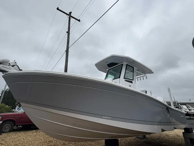 Slide: The Image of 2026 Blackfin 242HB boat with sleek design, displayed outdoors under cloudy sky. - 5