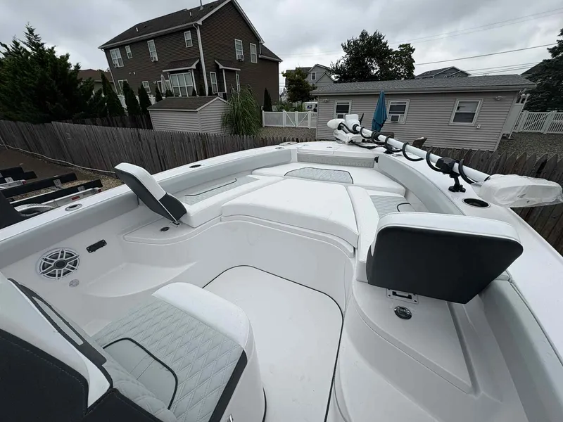 Slide: The Image of 2026 Blackfin 242HB boat interior with cushioned seating and fishing rod holders. - 8