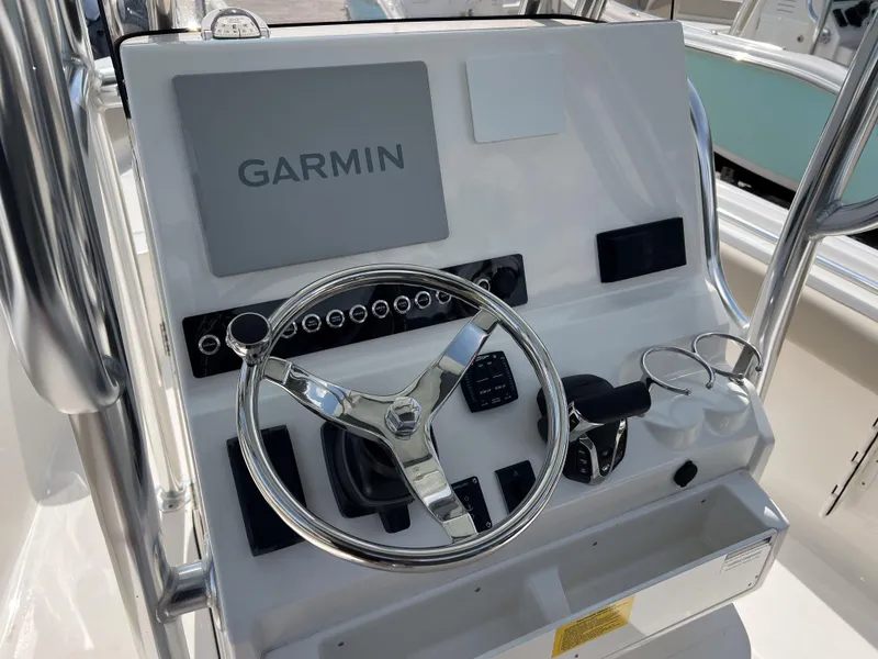 Slide: The Image of 2025 Key West 239 FS boat console with Garmin display and steering wheel. - 11