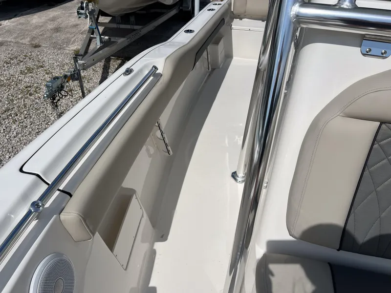 Slide: The Image of 2025 Key West 239 FS boat interior with beige seating and stainless steel railings. - 15