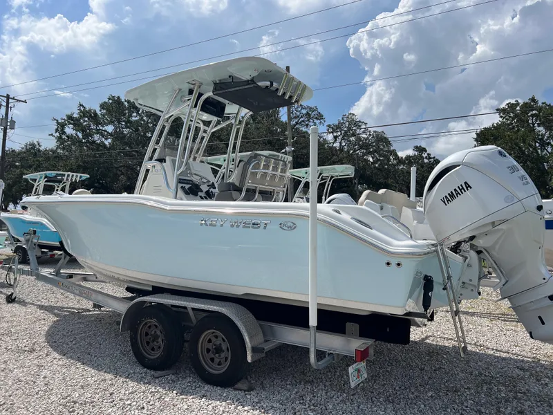 Slide: The Image of 2025 Key West 239 FS boat on trailer with Yamaha engine, parked outdoors. - 5
