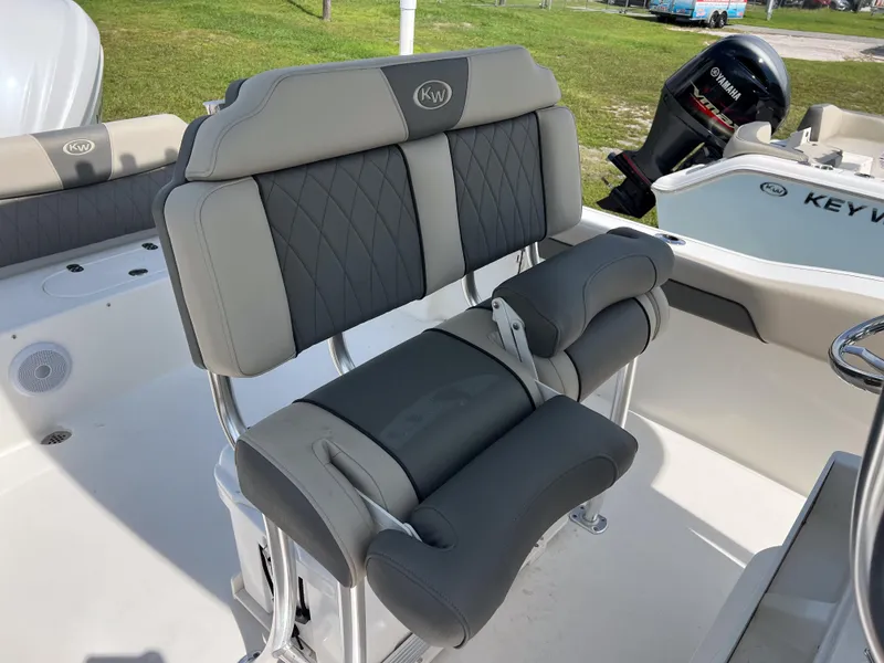 Slide: The Image of 2025 Key West 239 FS boat interior with gray cushioned seating and Yamaha engine. - 8