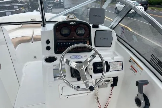 Slide: The Image of 2013 Sea Hunt Escape 211 LE boat dashboard with Garmin navigation system and steering wheel. - 11