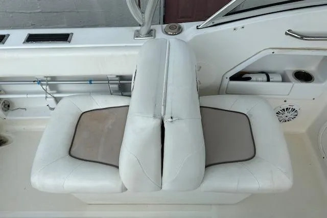 Slide: The Image of 2013 Sea Hunt Escape 211 LE boat interior with white cushioned seating. - 14