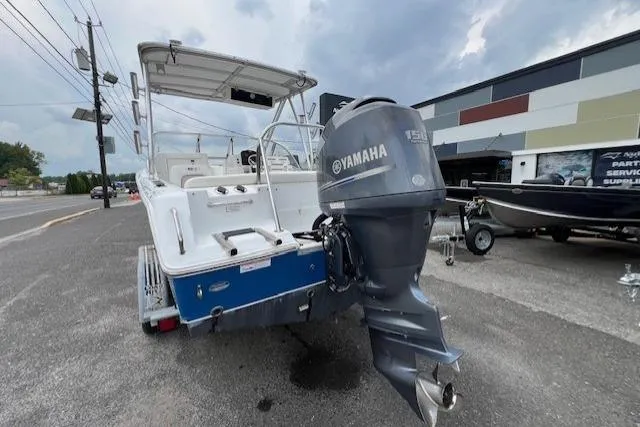 Slide: The Image of 2013 Sea Hunt Escape 211 LE boat with Yamaha outboard motor, parked outdoors. - 5