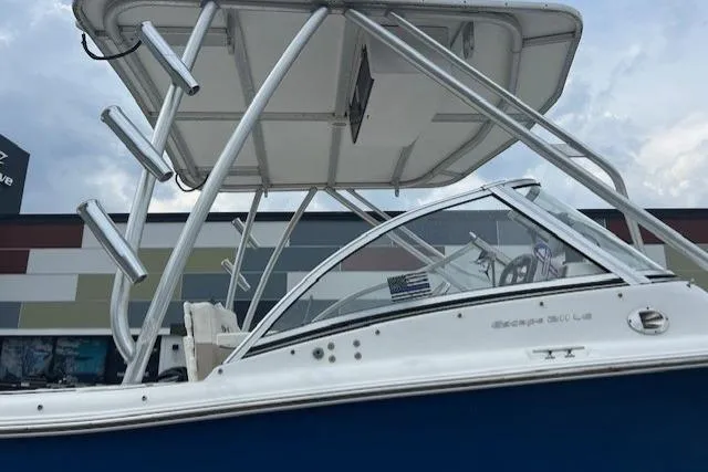 Slide: The Image of 2013 Sea Hunt Escape 211 LE boat with T-top and sleek design. - 6