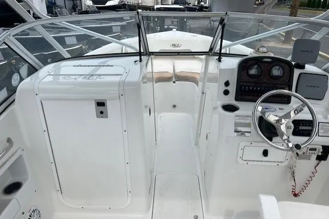 Slide: The Image of 2013 Sea Hunt Escape 211 LE boat interior with steering console and seating area. - 9