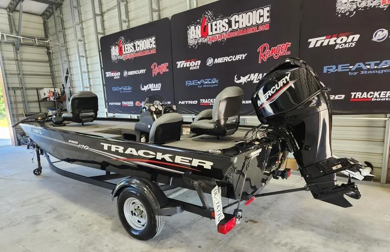 Slide: The Image of 2024 Tracker Pro 170 boat with Mercury engine in showroom setting. - 4