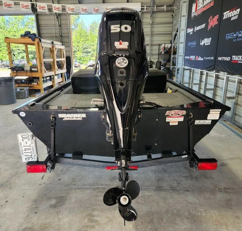 Slide: The Image of 2024 Tracker Pro 170 boat with Mercury 50 engine in a garage setting. - 5