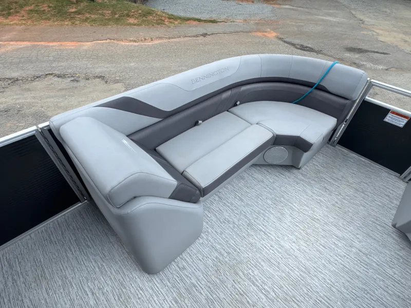 Slide: The Image of 2023 Bennington 22SX Swingback boat interior with gray cushioned seating. - 14