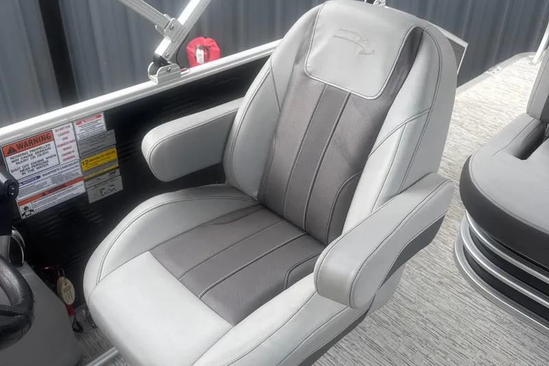 Slide: The Image of Captain's chair on 2023 Bennington 22SX SWINGBACK pontoon boat, featuring sleek gray upholstery. - 20