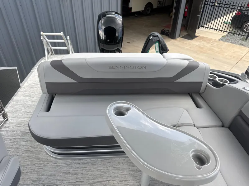 Slide: The Image of 2023 Bennington 22SX Swingback boat interior with seating and table. - 22