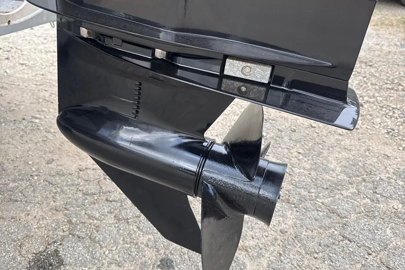 Slide: The Image of Close-up of a 2023 Bennington 22SX SWINGBACK boat propeller on a gravel surface. - 28