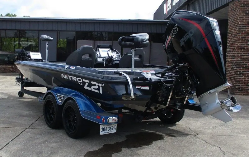 Slide: The Image of 2023 Nitro Z21 XL Pro boat with powerful outboard motor, parked on a trailer. - 3