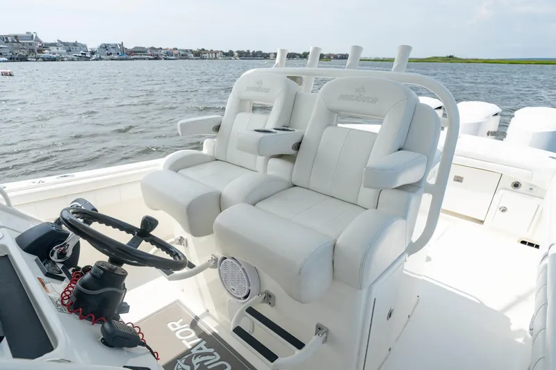Slide: The Image of 2019 Regulator 34 Center Console boat interior with white seating and steering wheel. - 11