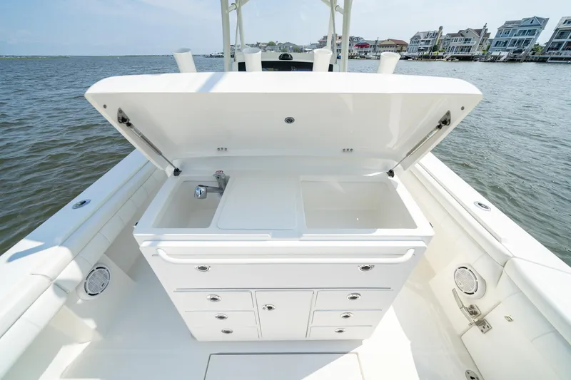 Slide: The Image of 2019 Regulator 34 Center Console boat with open storage compartment and sink. - 12