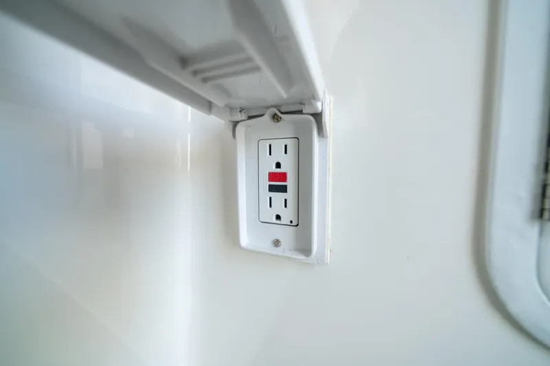 Slide: The Image of GFCI outlet on 2019 Regulator 34 Center Console boat interior. - 16