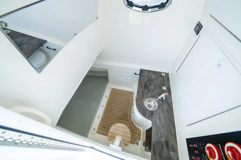 Slide: The Image of 2019 Regulator 34 Center Console interior with sink and toilet. - 17