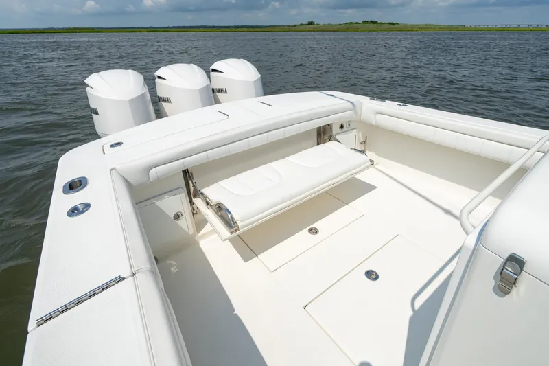 Slide: The Image of 2019 Regulator 34 Center Console boat with triple Yamaha engines on open water. - 18