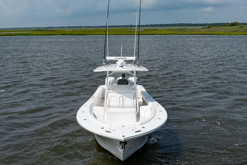 Slide: The Image of 2019 Regulator 34 Center Console boat cruising on open water. - 3