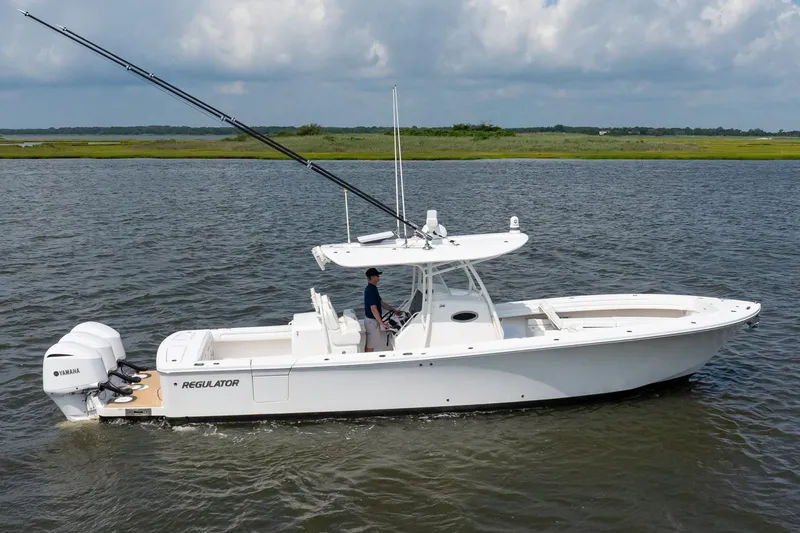 Slide: The Image of 2019 Regulator 34 Center Console boat on water with Yamaha engines. - 5