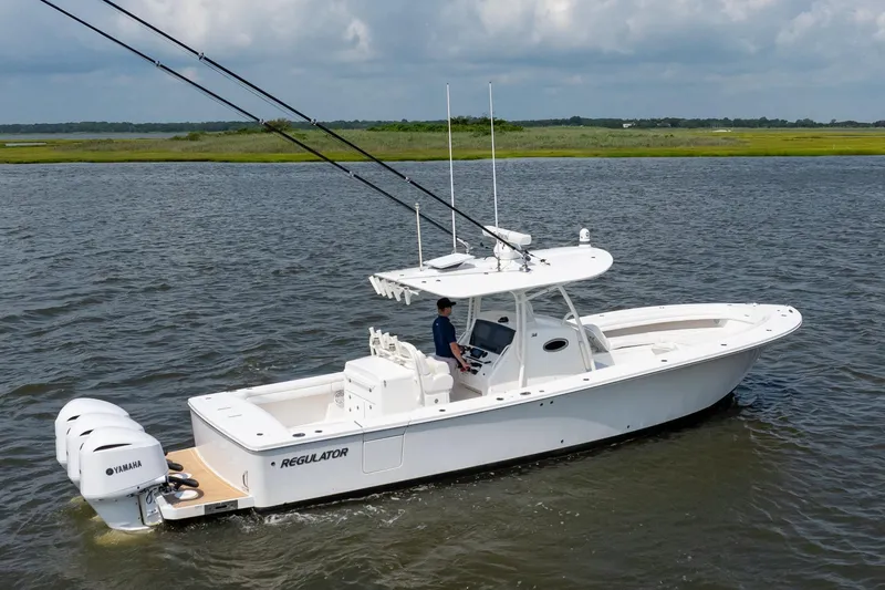 Slide: The Image of 2019 Regulator 34 Center Console boat cruising on open water. - 6