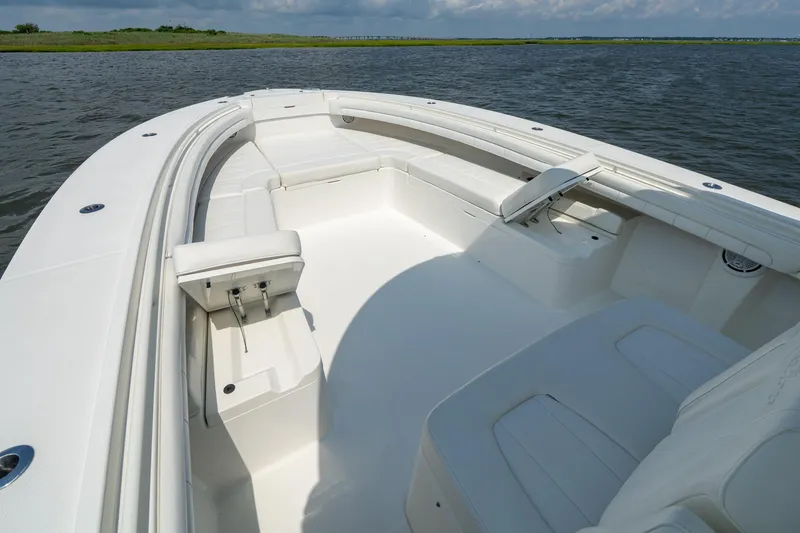 Slide: The Image of 2019 Regulator 34 Center Console boat interior with spacious seating on calm water. - 7