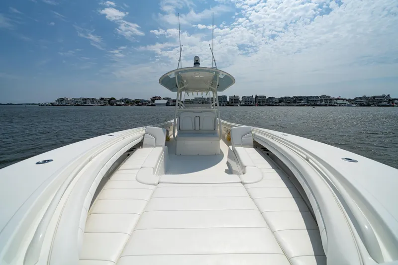 Slide: The Image of 2019 Regulator 34 Center Console boat on water, featuring spacious seating and clear skies. - 8