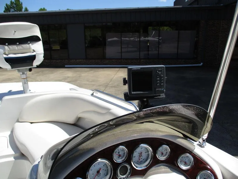 Slide: The Image of Dashboard of a 2011 Tahoe 195 boat with gauges and a Lowrance device. - 4