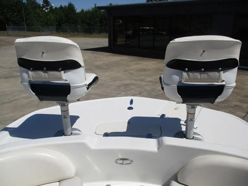 Slide: The Image of Two white boat seats on a 2011 Tahoe 195 deck, outdoors. - 6