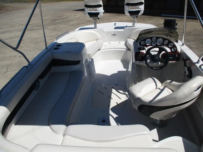 Slide: The Image of 2011 Tahoe 195 boat interior with white seating and modern dashboard controls. - 7