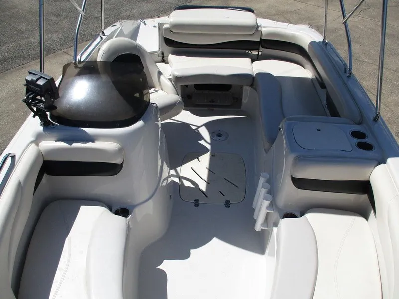 Slide: The Image of Interior of a 2011 Tahoe 195 boat with white seating and steering console. - 8