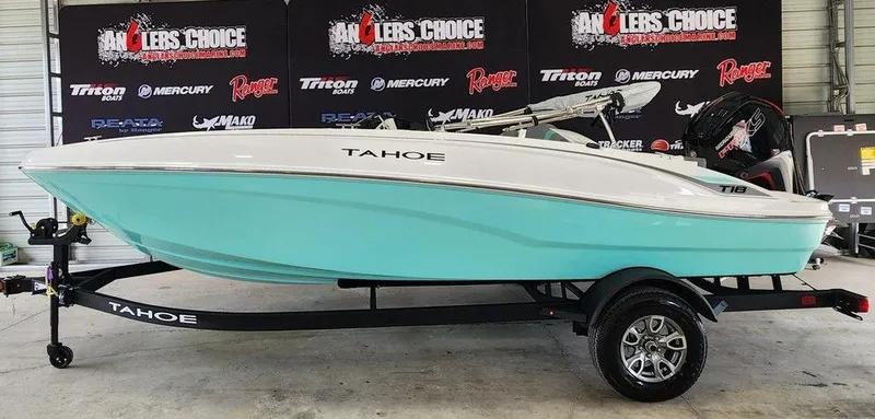 The Image of 2025 Tahoe T18 boat in showroom, turquoise hull, on trailer, Anglers Choice backdrop. - 1
