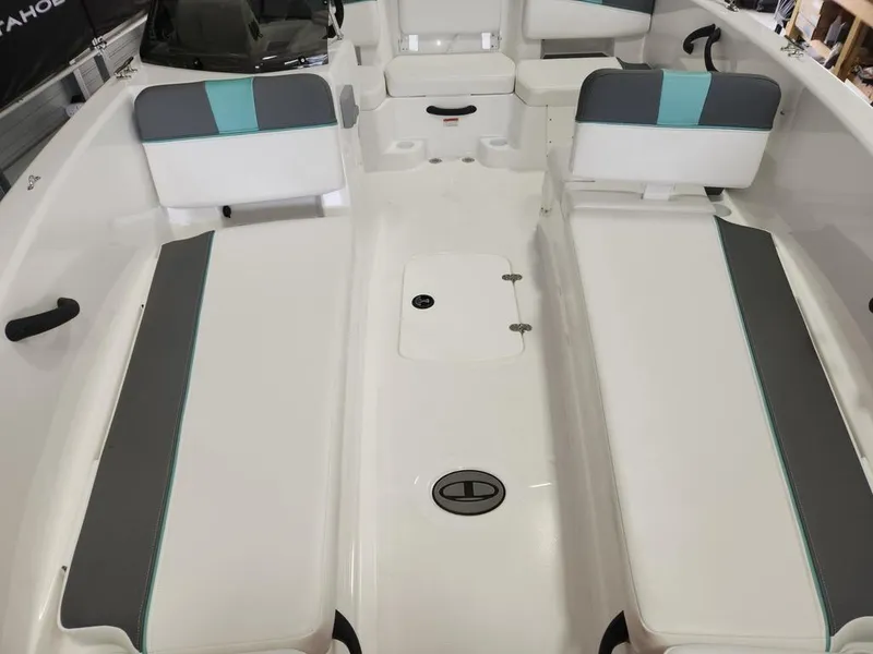 Slide: The Image of 2025 Tahoe T18 boat interior with white and gray seating, teal accents. - 11