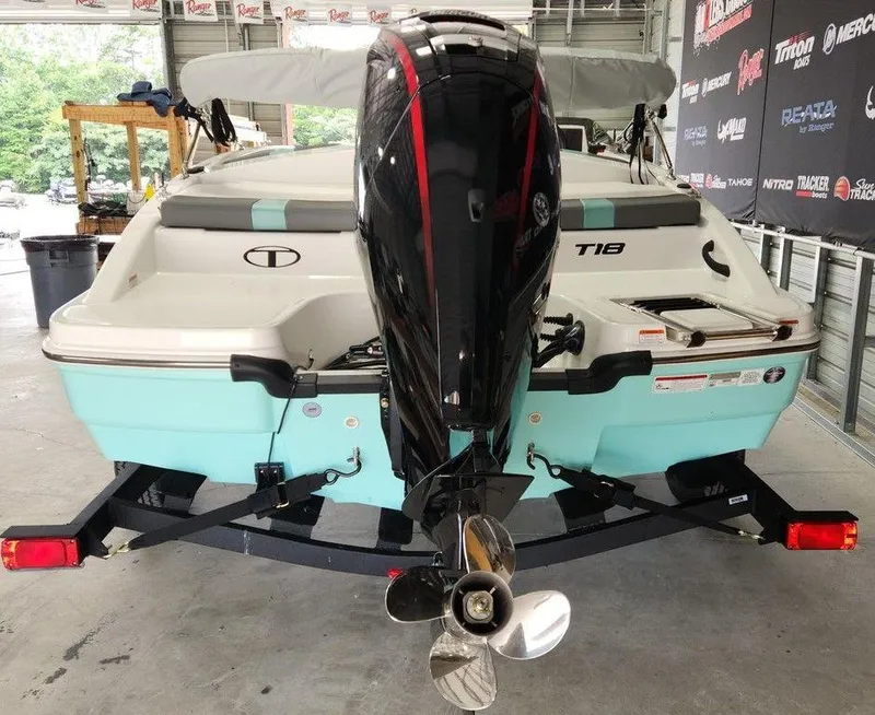 Slide: The Image of 2025 Tahoe T18 boat with outboard motor in a showroom. - 3