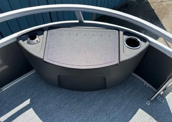 Slide: The Image of 2026 Sun Tracker Bass Buggy 18 DLX boat deck with cup holders and storage compartment. - 12