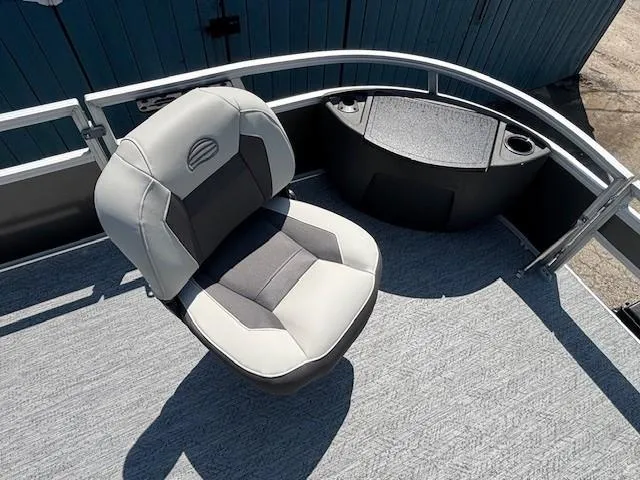 Slide: The Image of 2026 Sun Tracker Bass Buggy 18 DLX boat seat with gray upholstery and railing. - 14