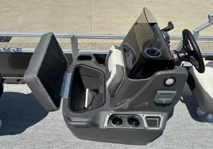 Slide: The Image of 2026 Sun Tracker Bass Buggy 18 DLX console with storage compartment and steering wheel. - 19
