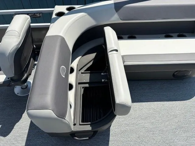 Slide: The Image of 2026 Sun Tracker Bass Buggy 18 DLX boat interior with gray seating and storage compartment. - 22