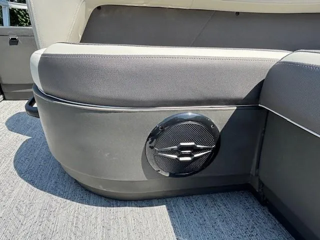 Slide: The Image of 2026 Sun Tracker Bass Buggy 18 DLX boat interior with speaker and cushioned seating. - 26