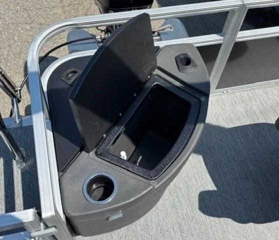 Slide: The Image of 2026 Sun Tracker Bass Buggy 18 DLX boat storage compartment with open lid. - 29