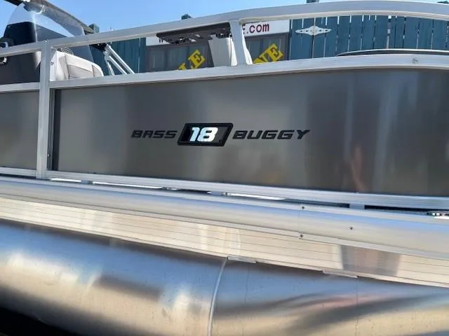 Slide: The Image of 2026 Sun Tracker Bass Buggy 18 DLX pontoon boat side view with logo. - 8