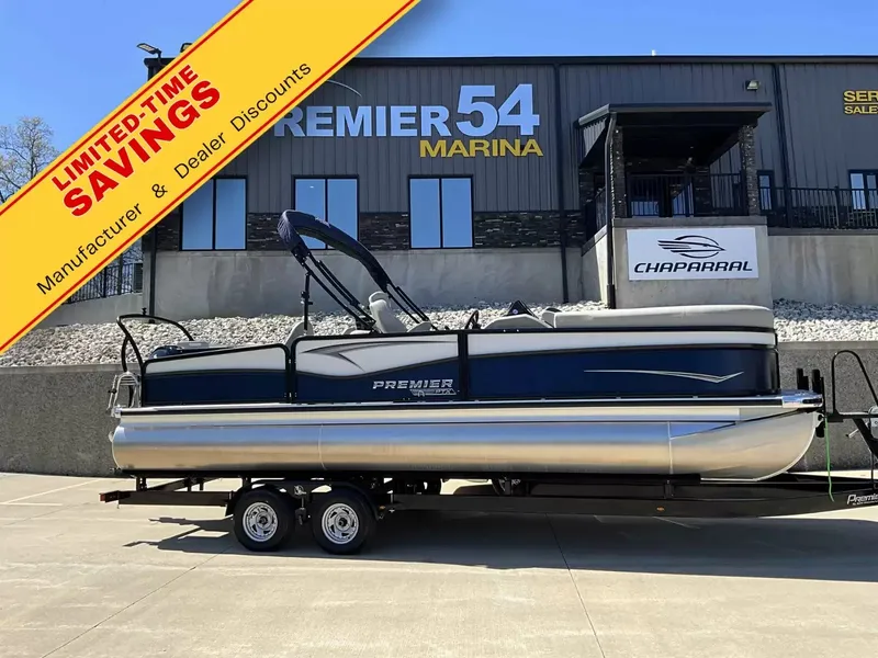 The Image of A 2024 Premier 230 Sunsation Angler 2pt on a trailer in front of a building. - 1