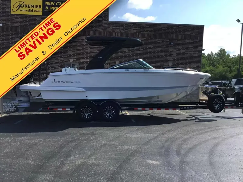 The Image of The image shows a Chaparral 270 OSX boat on a trailer in front of a building. - 1