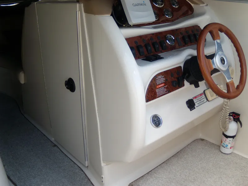 Slide: The Image of 2001 Sea Ray 260 Bow Rider Select dashboard with Garmin GPS and wooden steering wheel. - 16