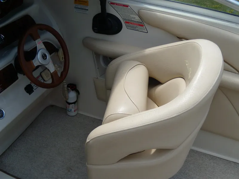 Slide: The Image of 2001 Sea Ray 260 Bow Rider Select interior with beige seating and steering wheel. - 17