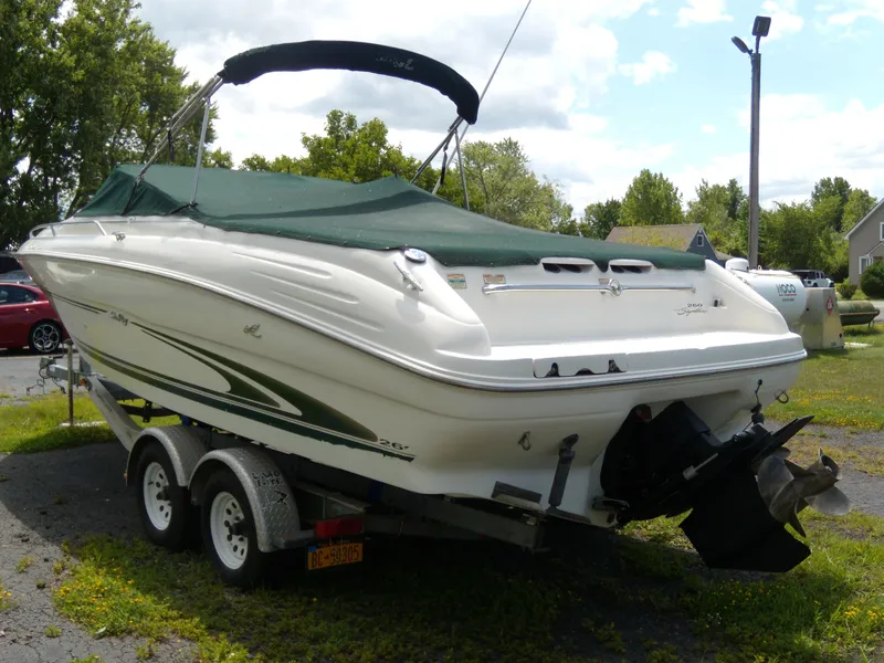 Slide: The Image of 2001 Sea Ray 260 Bow Rider Select boat on trailer, covered and parked outdoors. - 3