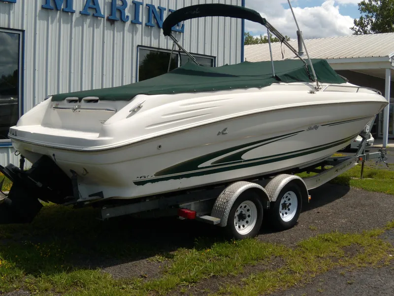 Slide: The Image of 2001 Sea Ray 260 Bow Rider Select on trailer, covered, parked outside marine building. - 4