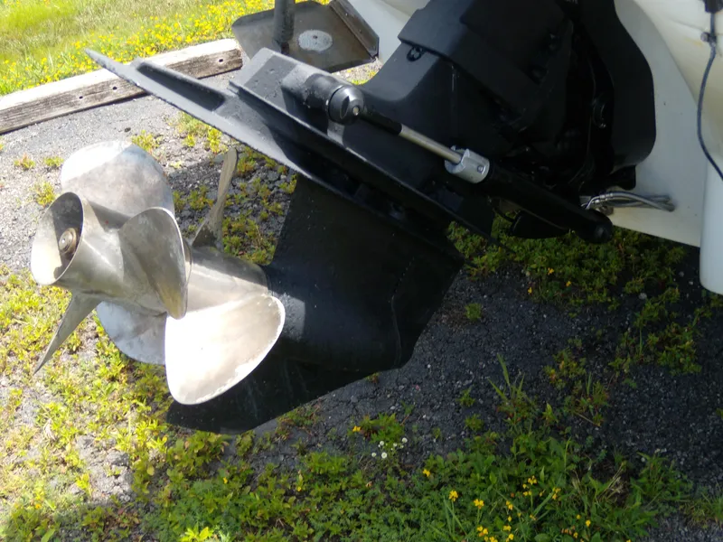 Slide: The Image of Propeller and outdrive of 2001 Sea Ray 260 Bow Rider Select on gravel and grass. - 5