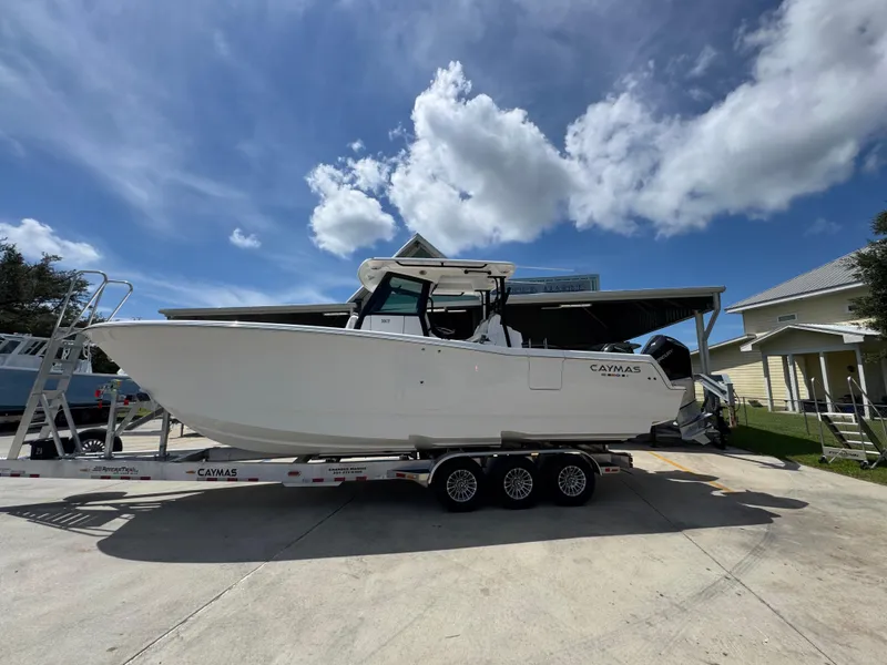 The Image of 2026 Caymas 30 CT boat on trailer under blue sky with clouds. - 1